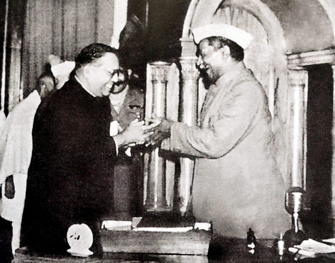 Ambedkar, chairman of the Drafting Committee, presenting the final draft of the Indian Constitution to Rajendra Prasad