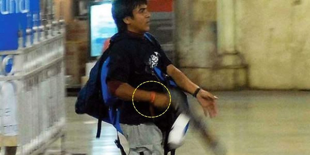 A picture of Kasab also shows him with a red thread tied around his wrist