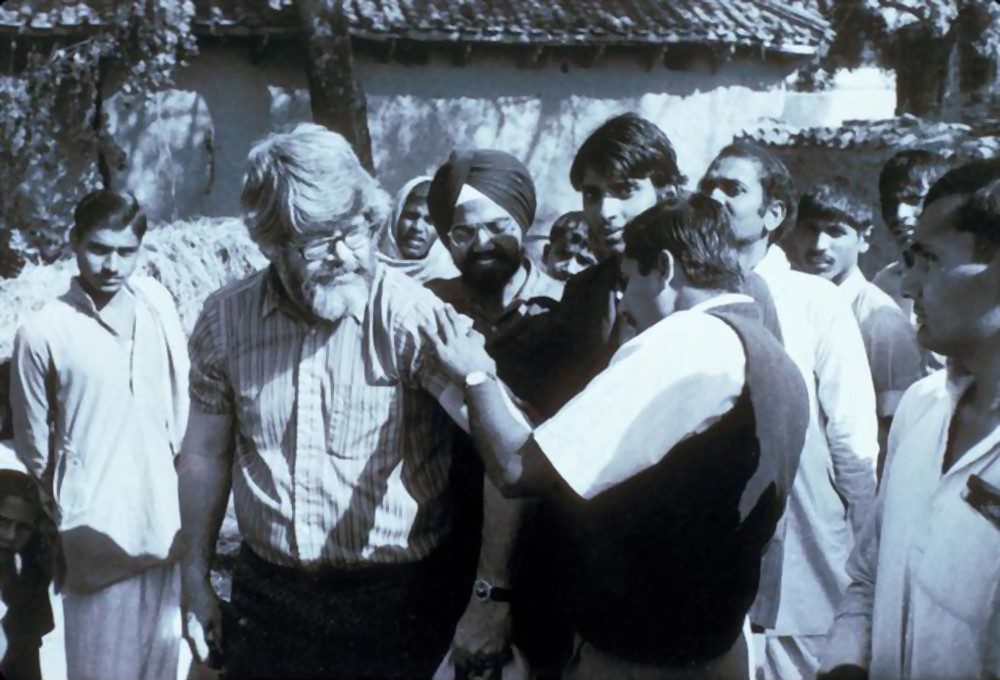 Physician Dr. A. Khan examines the scar from a successful smallpox vaccination on Dr. J. Donald Millar a WHO Central Assessment Officer from the CDC is seen Bhojpur District Bihar India 1975